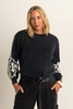 Sweater met contrasterende borduusels